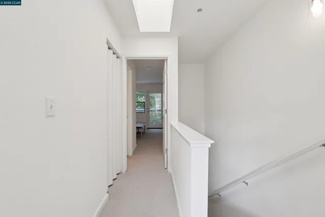 a view of a hallway with a white cabinet and a yard
