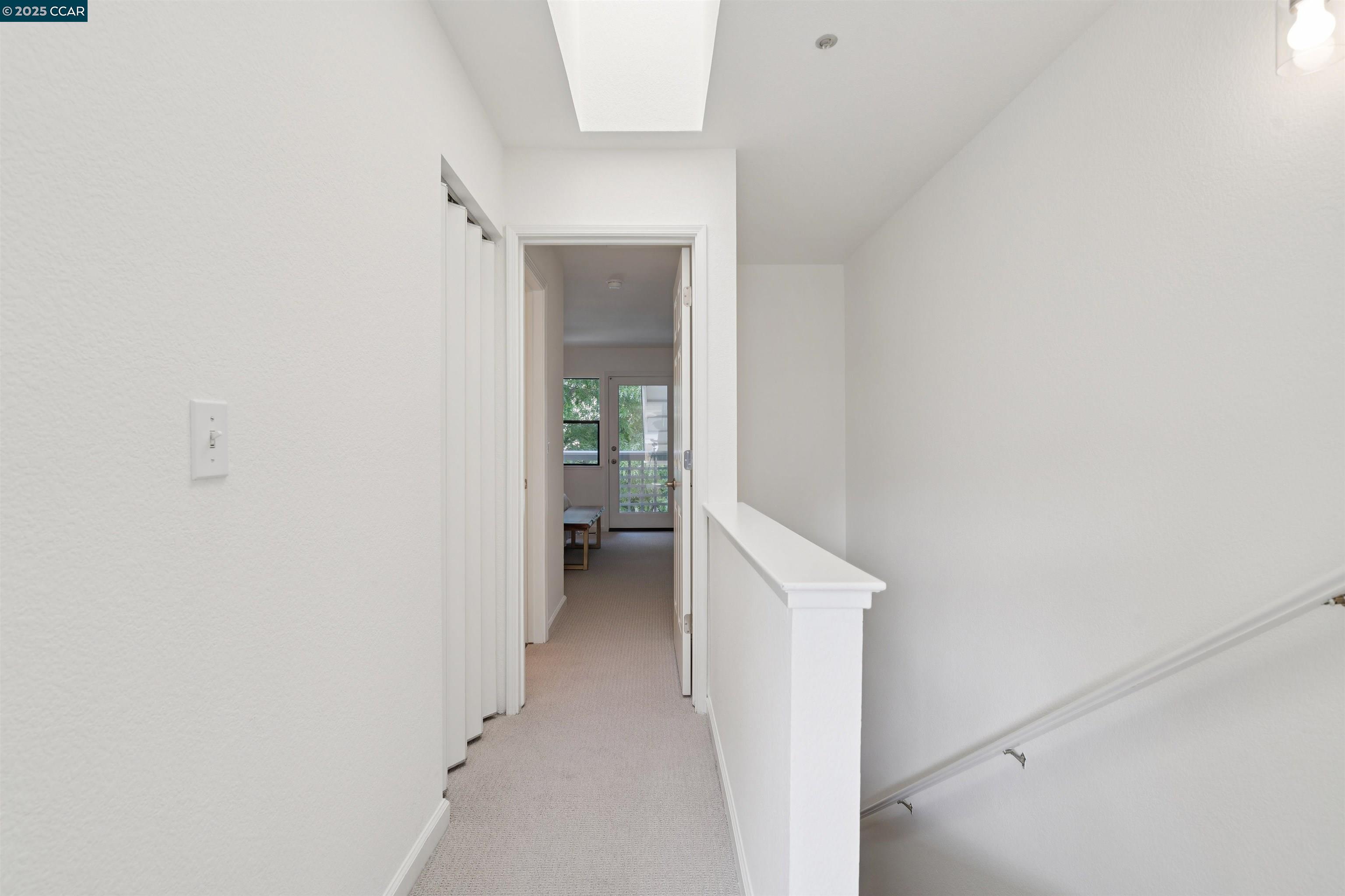 2578 Oak Road, Unit 212 Walnut Creek, CA 94597 - Photo 12 of 27 a view of a hallway with a white cabinet and a yard