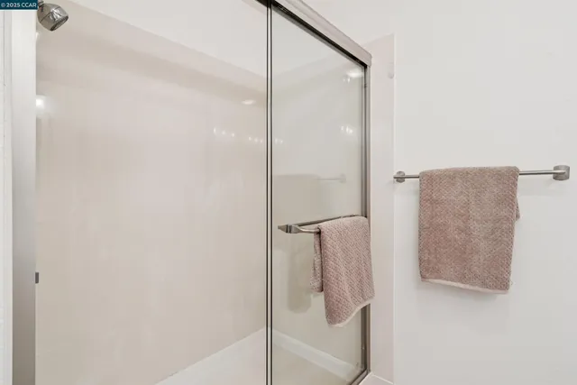 a bathroom with a glass shower door