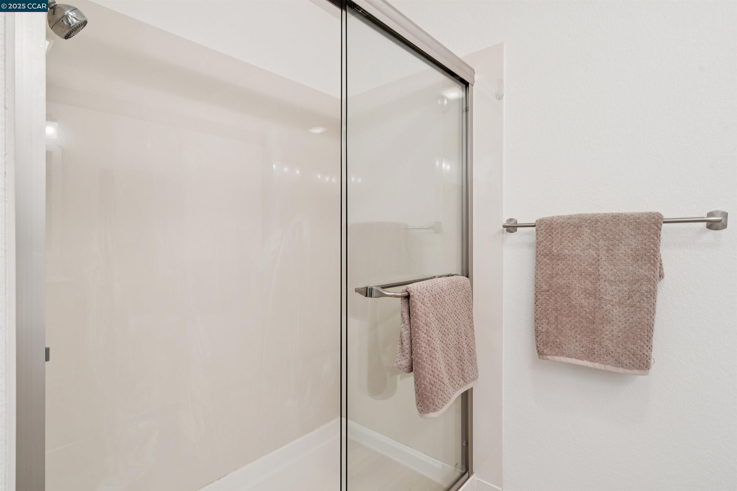 2578 Oak Road, Unit 212 Walnut Creek, CA 94597 - Photo 16 of 27 a bathroom with a glass shower door