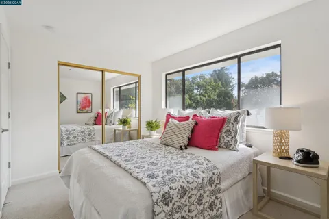 a bedroom with a large bed and a large window