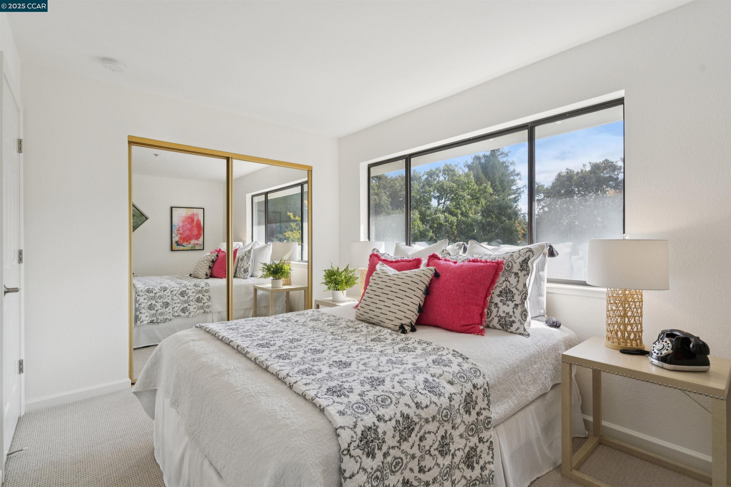 2578 Oak Road, Unit 212 Walnut Creek, CA 94597 - Photo 20 of 27 a bedroom with a large bed and a large window