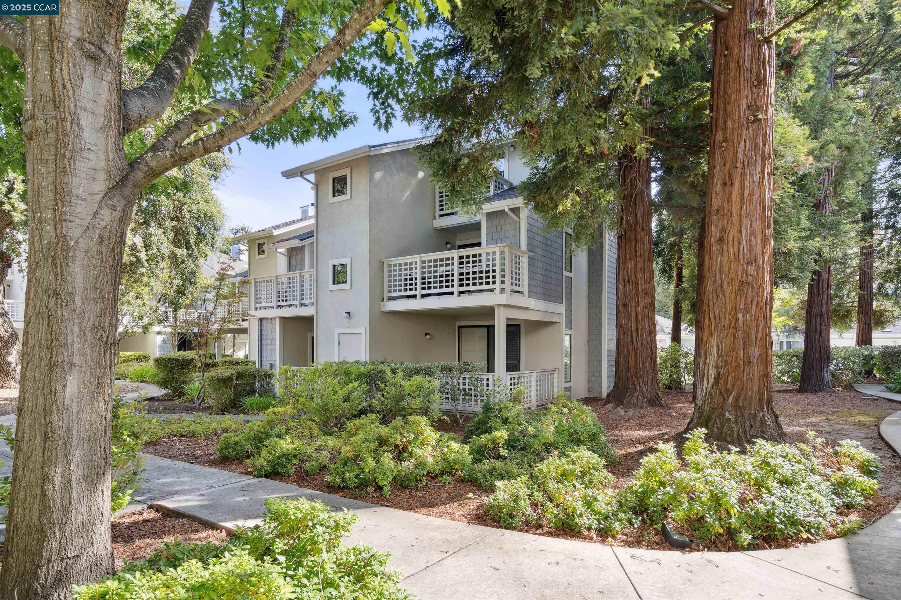 2578 Oak Road, Unit 212 Walnut Creek, CA 94597 - Photo 23 of 27 a front view of a house with a garden