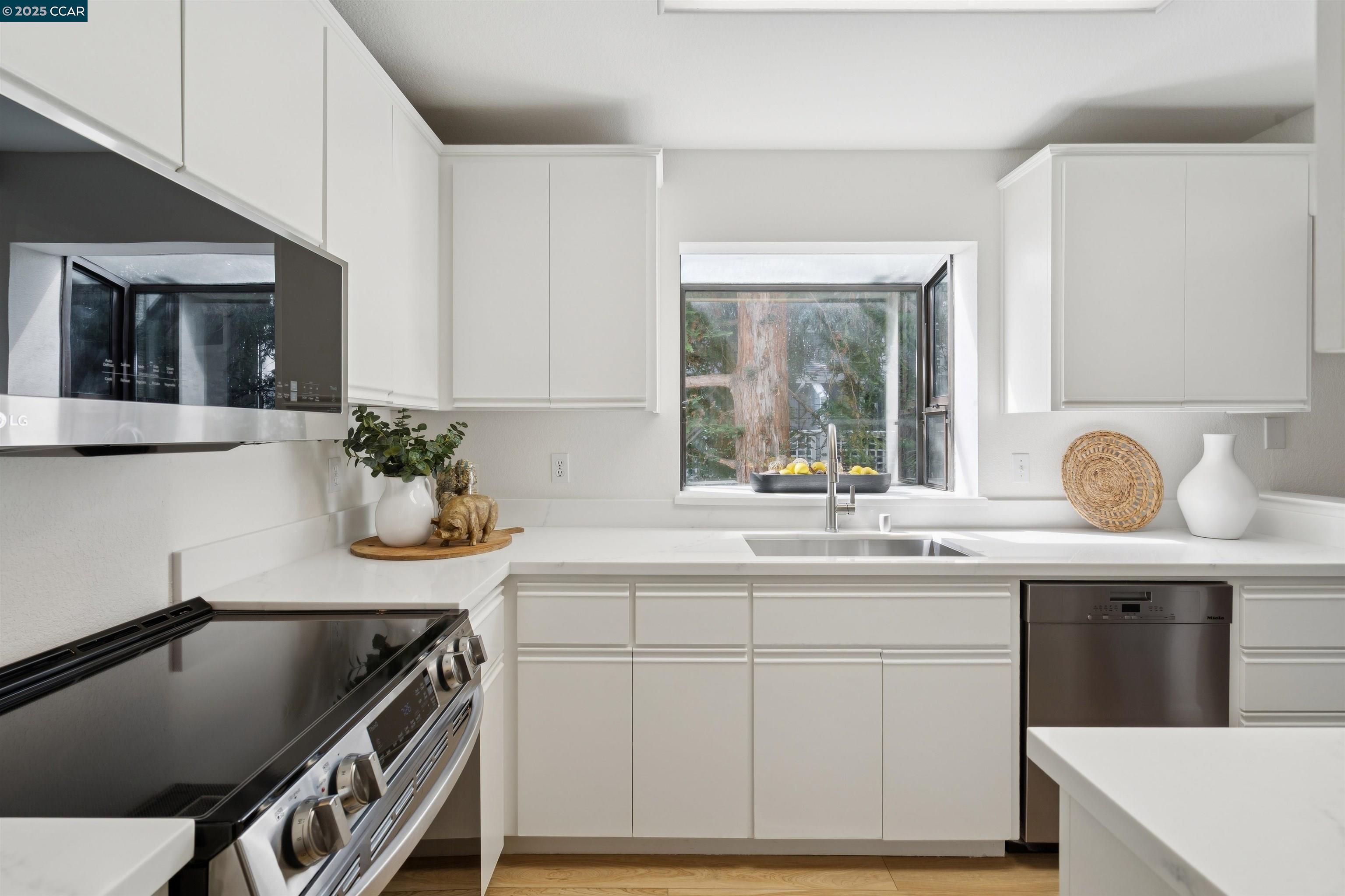 2578 Oak Road, Unit 212 Walnut Creek, CA 94597 - Photo 5 of 27 a kitchen with a sink a stove and cabinets