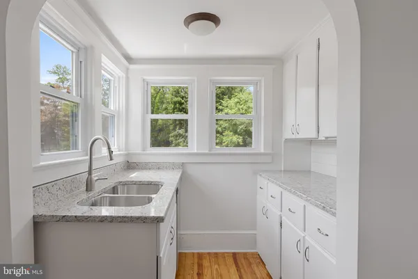 a kitchen with granite countertop a sink and a window