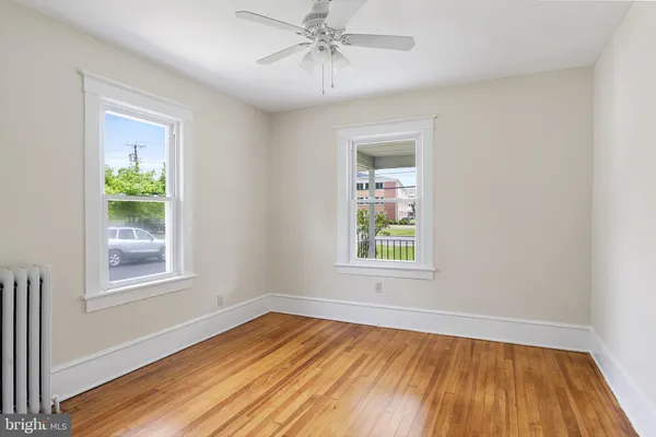 an empty room with window and wooden floor