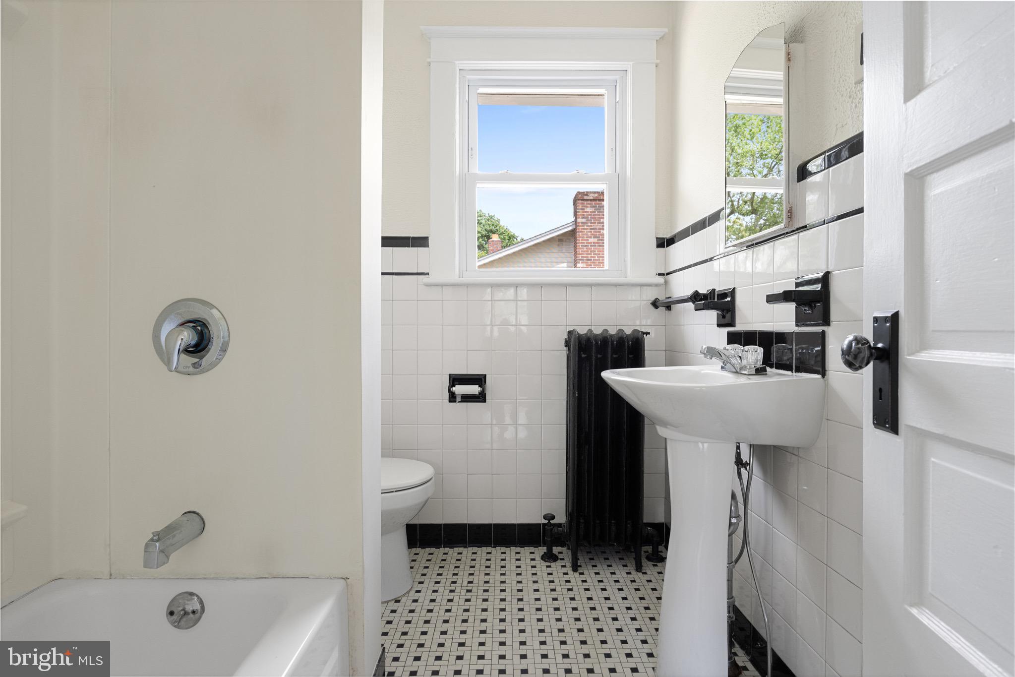 1842 South Spring Road Vineland, NJ 08361 - Photo 20 of 22 a bathroom with a sink a mirror and a bathtub