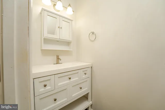 a bathroom with a sink a vanity and a mirror