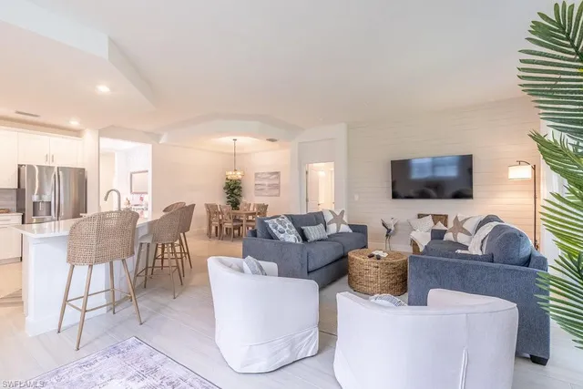 a bedroom with a bed and a flat tv screen on dresser