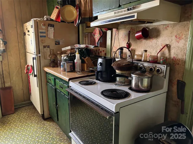 a kitchen with a stove and cabinets