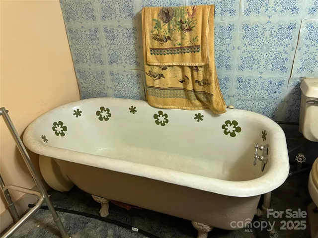 a bath tub sitting in a bathroom next to a sink
