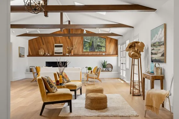 a living room with furniture a rug and a chandelier
