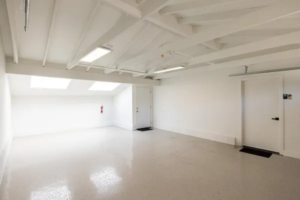 a view of backyard with a table and chairs with wooden fence
