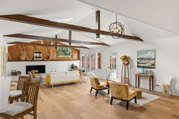 a dining room with furniture and a wooden floor