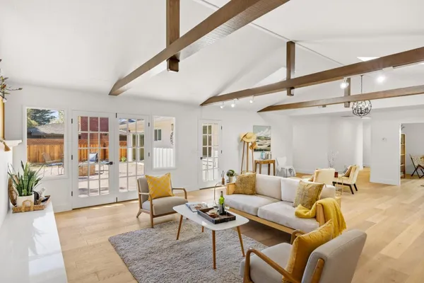 a living room with furniture and wooden floor