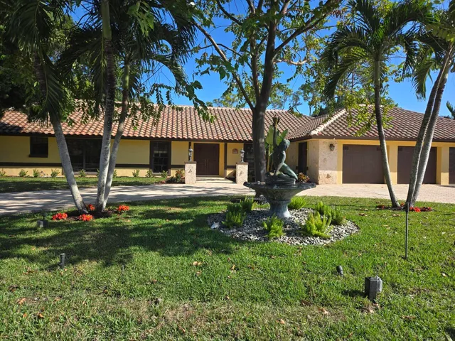a view of a house with backyard porch and sitting area
