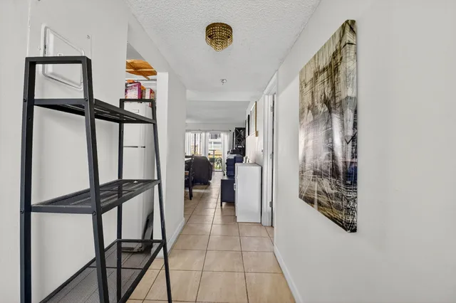 a view of hallway with stairs and furniture