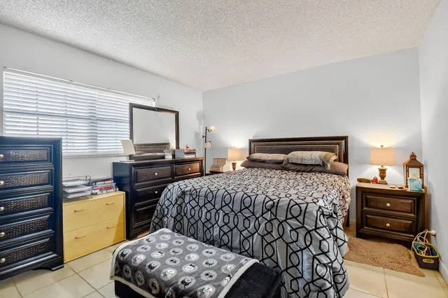 a bedroom with a bed and a tv