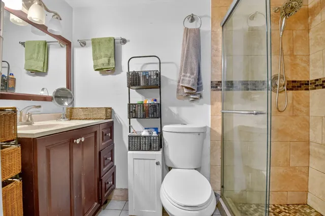 a bathroom with a sink a toilet and shower