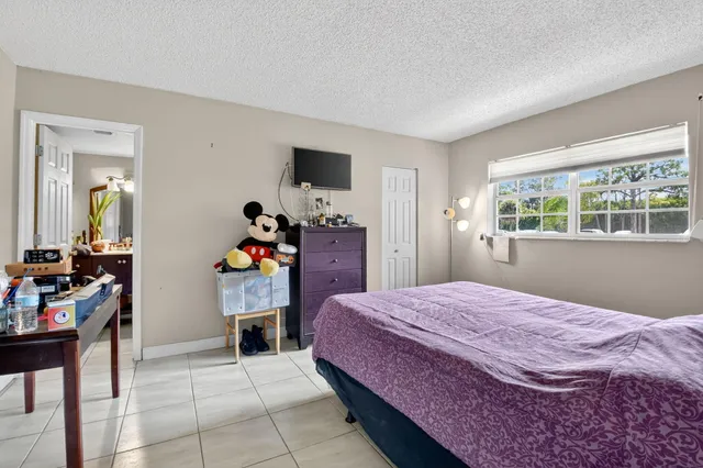 a bedroom with a bed and a dresser in it