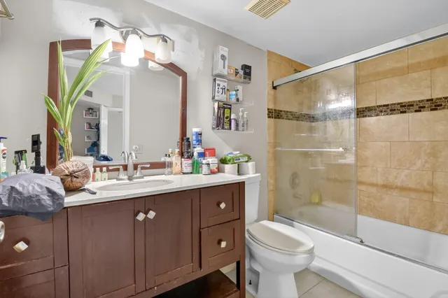 a bathroom with a sink vanity mirror and toilet
