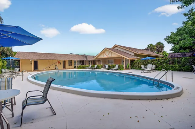 a view of house with a swimming pool