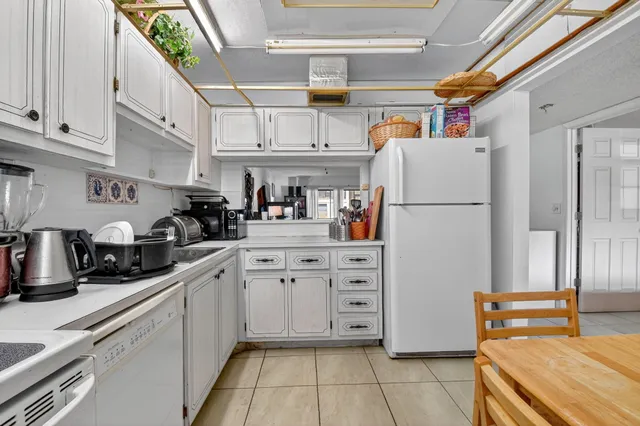 a kitchen with refrigerator and cabinets