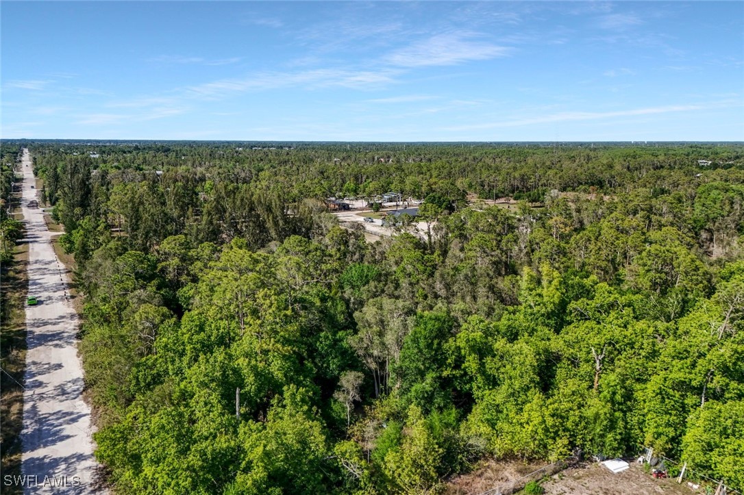 12571 Shawnee Road Fort Myers, FL 33913 - Photo 9 of 15 an aerial view of residential houses with outdoor space and trees