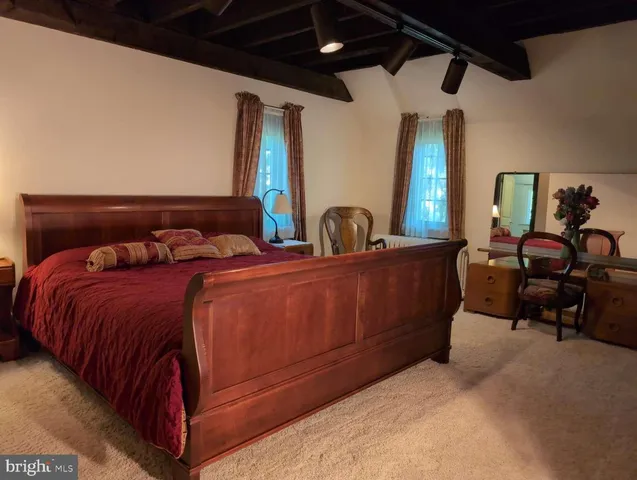 a bedroom with bed and window