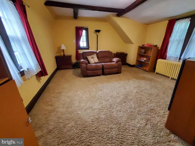 a bedroom with a bed and a mirror on dresser