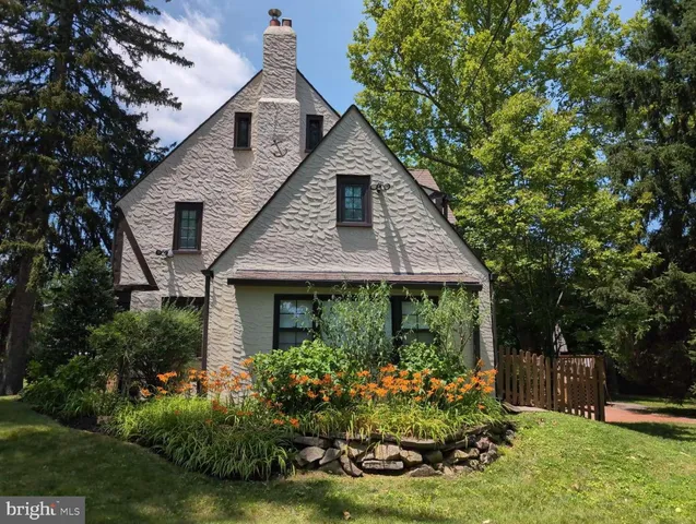 a front view of house with a garden