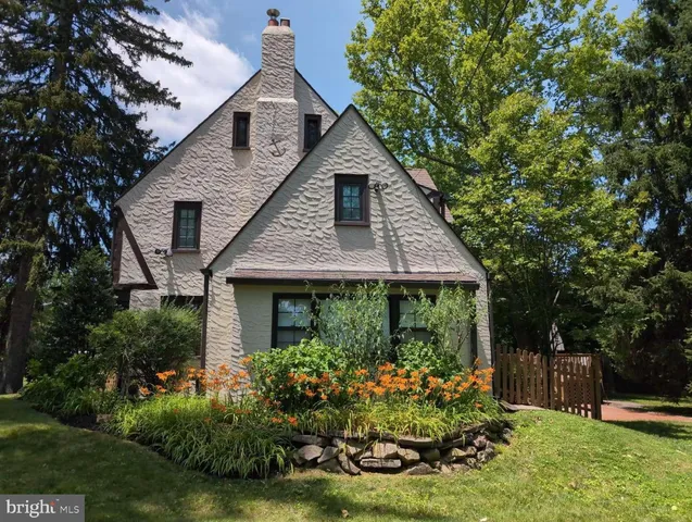 a front view of house with a garden