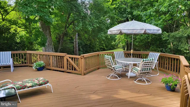 a view of balcony with wooden floor and outdoor seating