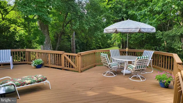 a view of balcony with wooden floor and outdoor seating
