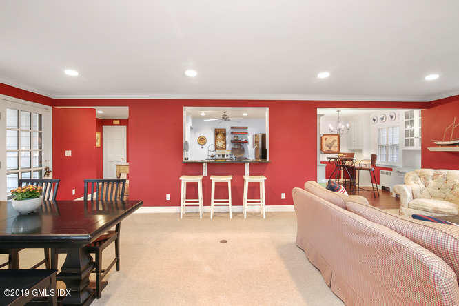 42 Indian Field Road Greenwich, CT 06830 - Photo 13 of 43 a living room with furniture a flat screen tv and a large window