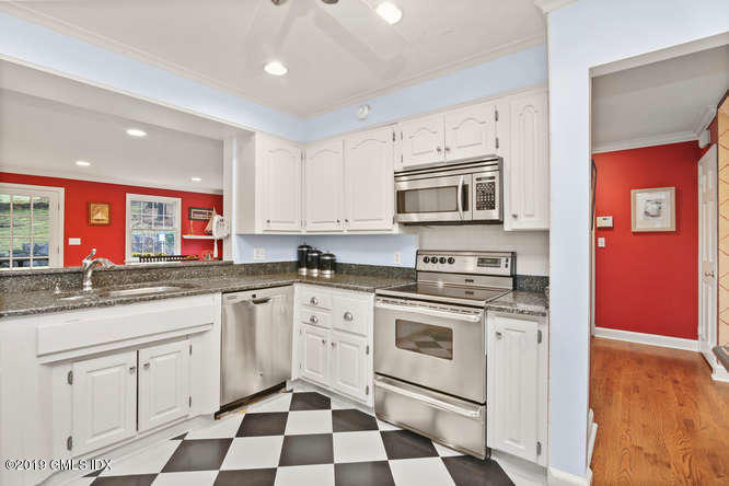 42 Indian Field Road Greenwich, CT 06830 - Photo 19 of 43 a kitchen with stainless steel appliances granite countertop a stove a sink and a microwave