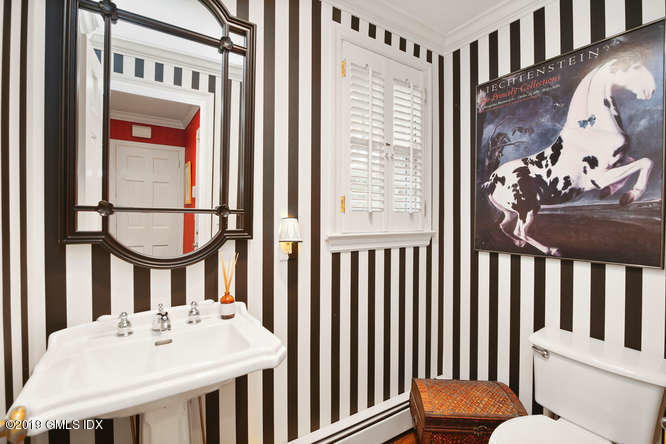 42 Indian Field Road Greenwich, CT 06830 - Photo 20 of 43 a bathroom with a sink a mirror and a window