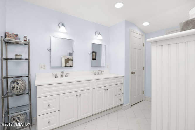 42 Indian Field Road Greenwich, CT 06830 - Photo 24 of 43 a bathroom with a double vanity sink and mirror