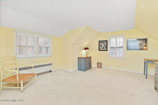 42 Indian Field Road Greenwich, CT 06830 - Photo 28 of 43 a spacious bedroom with a bed and a cabinets