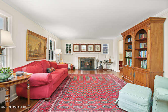 42 Indian Field Road Greenwich, CT 06830 - Photo 6 of 43 a living room with furniture fireplace and flat screen tv