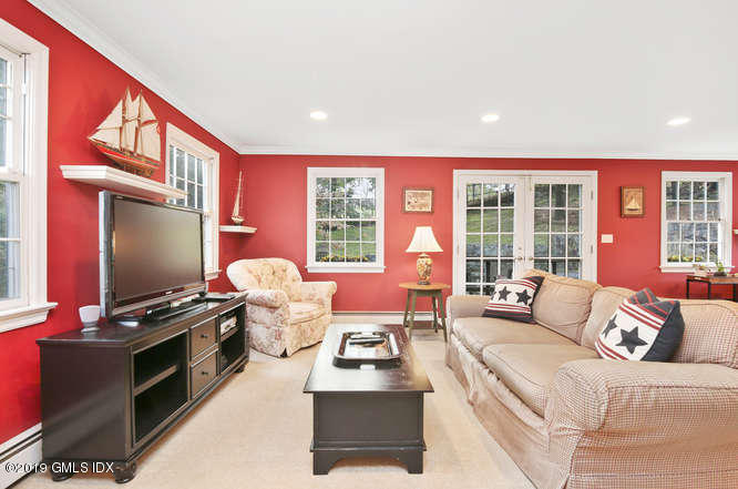 42 Indian Field Road Greenwich, CT 06830 - Photo 10 of 43 a living room with furniture and a flat screen tv
