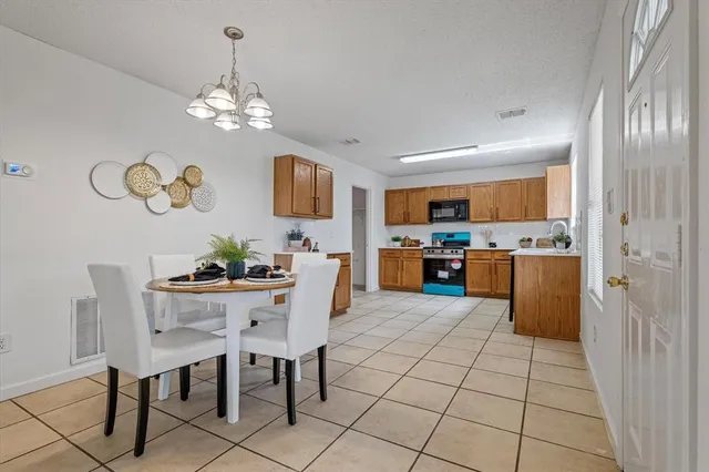 a view of kitchen with granite countertop microwave and refrigerator