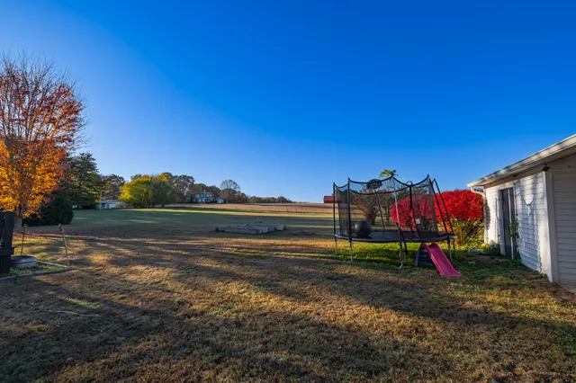 a view of a house with a yard and garage
