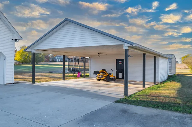 a view of a parking space with a patio