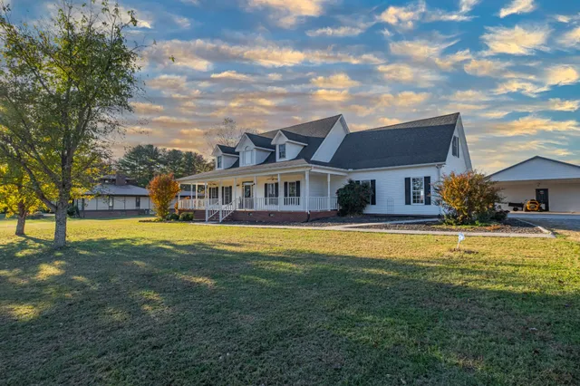 a front view of a house with swimming pool having outdoor seating