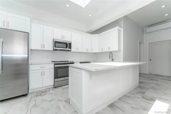 a kitchen with stainless steel appliances granite countertop a refrigerator sink and stove