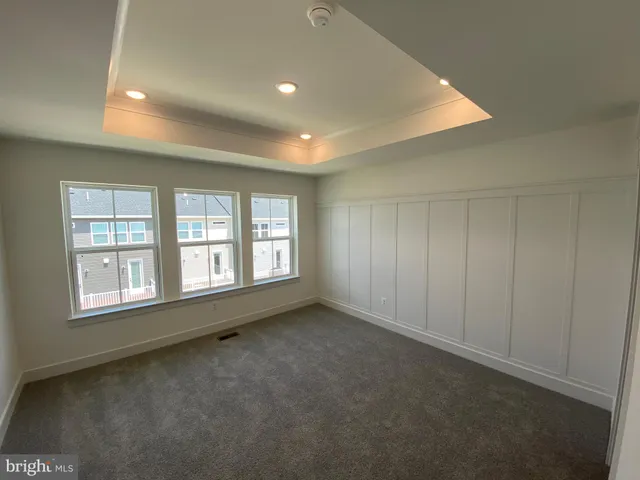 an empty room with a empty space and windows