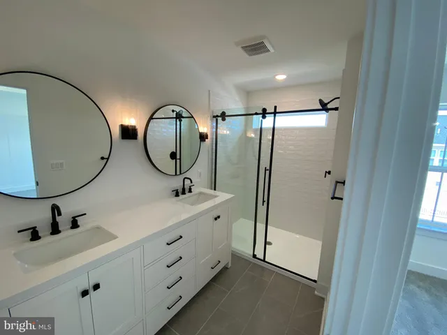 a bathroom with a sink mirror toilet and shower