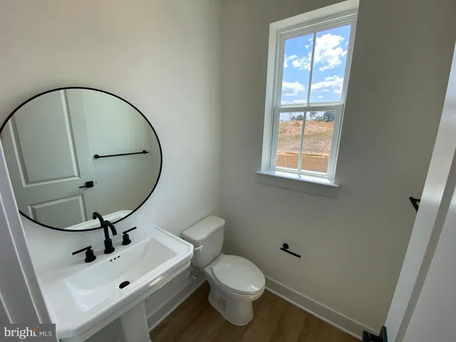 an empty room with windows and entrance to other room