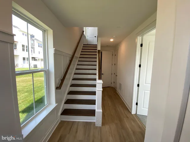 a view of entryway with wooden floor and windows